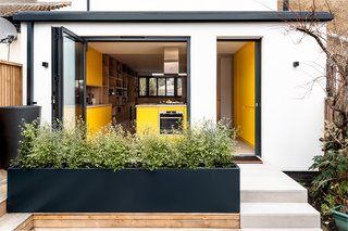 Expansive glazed pocket and bifold doors open the ground level to a newly landscaped garden area with terrace seating.