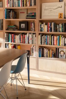 During the top-down overhaul, the team created a floor-to-ceiling, modular, and adjustable birch-ply storage wall—perfect for displaying books, photos, and memorabilia.