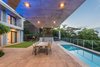 Modern home with Outdoor, Back Yard, Small Pools, Tubs, Shower, Stone Patio, Porch, Deck, Grass, Hanging Lighting, and Large Patio, Porch, Deck. A glass skin of sliding doors links the view, and extends the interior onto a covered patio, pool deck and boma. Photo 9 of City View House