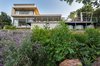 Modern home with Exterior, Concrete Siding Material, Metal Roof Material, Glass Siding Material, House Building Type, and Flat RoofLine. A concrete frame collects rainwater from the roof and diverts the water to galvanized rainwater tanks. These rainwater tanks are expressed as architectural features around the house, and below the pool deck. Photo 11 of City View House
