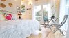 Modern home with Dining Room, Medium Hardwood Floor, Chair, Table, and Wall Lighting. Living area looking towards the glass french door entrance. Photo 8 of Romantic Tree Cottage in the Hawaiian Rainforest