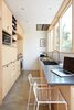 Modern home with Kitchen, Wall Oven, Range Hood, Microwave, Engineered Quartz Counter, Wood Cabinet, Laminate Cabinet, Concrete Floor, Recessed Lighting, Undermount Sink, and Ceramic Tile Backsplashe. galley kitchen looking west Photo of K Street Addition