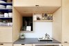 Modern home with Kitchen, Engineered Quartz Counter, Wood Cabinet, Laminate Cabinet, Ceramic Tile Backsplashe, Open Cabinet, and Recessed Lighting. plywood cabinets creep through opening in original exterior wall Photo 4 of K Street Addition