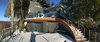 Modern home with Staircase and Wood Railing. Wide shot from Hot Tub Deck Photo 2 of Cortes Island Custom Blu Prefab