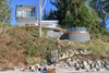 Modern home with Outdoor, Front Yard, Slope, Trees, Shrubs, Large Patio, Porch, Deck, and Wood Patio, Porch, Deck. View up from the beach Photo 4 of Cortes Island Custom Blu Prefab