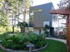 Modern home with Outdoor, Back Yard, Trees, Grass, Hardscapes, Walkways, Gardens, Shrubs, and Wood Fences, Wall. Back yard upon entry Photo 6 of Cortes Island Custom Blu Prefab