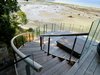 Modern home with Staircase, Wood Railing, and Wood Tread. Curved Stairs Down to Hot Tub Deck Photo 15 of Cortes Island Custom Blu Prefab