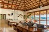Modern home with Kitchen, Concrete Floor, Wood Cabinet, Mosaic Tile Backsplashe, Ceiling Lighting, Pendant Lighting, and Accent Lighting. The kitchen, bar, living and dining areas coalesce with the pool outside and the nature beyond...all under the cover of a 20' illuminated palapa. Photo 4 of Esquina Del Cielo