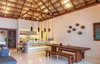 The kitchen sits at the heart of the space, featuring oversized, swinging bar seats. Combining local craftsmanship and materials with state of the art appliances the minimal kitchen is supported by a full butler's kitchen in the back and accessible by a separate service entrance. Photo 7 of Esquina Del Cielo modern home