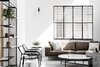 Modern home with Living Room, Sofa, Chair, Ottomans, Coffee Tables, Bookcase, and Wall Lighting. Hand made concrete tables by Shmuel Linski, leather armchairs and sofa and iron and wood screen. Photo 3 of Nir Am House