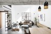 Modern home with Living Room, Chair, Sofa, Bookcase, Coffee Tables, Pendant Lighting, Wall Lighting, Ceiling Lighting, and Concrete Floor. The entrance, living room, and Mika :) Photo of Nir Am House
