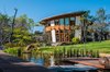 Modern home with Exterior, Green Siding Material, Curved RoofLine, and House Building Type. View from natural pool Photo 2 of CASA LOBO