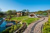 Modern home with Exterior, Green Siding Material, House Building Type, and Green Roof Material. Entrance view Photo 6 of CASA LOBO