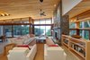 Modern home with Living Room, Coffee Tables, Sofa, Ceiling Lighting, Recessed Lighting, Concrete Floor, and Wood Burning Fireplace. living room Photo 3 of Stanley Bay House