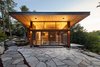 Modern home with Exterior, House, Metal Roof Material, Flat RoofLine, Wood Siding Material, Beach House Building Type, and Butterfly RoofLine. side view with lift and slides onto stone terrace cliff Photo 7 of Stanley Bay House