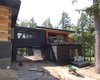 Modern home with Exterior, House, Beach House Building Type, Metal Roof Material, Wood Siding Material, Glass Siding Material, and Flat RoofLine. under construction Photo 2 of Tucker Lake Cottage