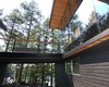 Modern home with Exterior, Metal Roof Material, House, Beach House Building Type, Wood Siding Material, Glass Siding Material, and Flat RoofLine. bridge detail Photo 6 of Tucker Lake Cottage