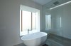 Modern home with Bath Room, Concrete Wall, Concrete Floor, Enclosed Shower, Recessed Lighting, and Freestanding Tub. Master bathroom with backlit pop out wind boxes. Photo 16 of Stouffville Residence