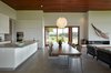 Modern home with Dining Room, Storage, Pendant Lighting, Bar, Recessed Lighting, Table, Gas Burning Fireplace, and Concrete Floor. Dining Room looking out onto side patio Photo 17 of Stouffville Residence