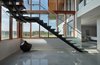Modern home with Staircase, Metal Railing, Glass Railing, Concrete Tread, and Metal Tread. Sleek concrete tread stair meets polished concrete flooring on lower level Photo 18 of Stouffville Residence