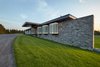 Modern home with Exterior, House Building Type, Metal Roof Material, Wood Siding Material, Stone Siding Material, Flat RoofLine, and Glass Siding Material. The approach featuring glass boxes Photo of Stouffville Residence