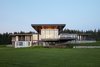 Modern home with Exterior, Glass Siding Material, Stone Siding Material, House Building Type, Wood Siding Material, Metal Roof Material, and Flat RoofLine. Rear view onto vast landscape with strong lines, custom curtain wall and large overhangs to protect form the sunlight Photo 2 of Stouffville Residence