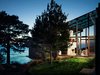 Modern home with Office, Storage, Library Room Type, Bookcase, Chair, and Limestone Floor. View of library at night Photo 18 of Fall House