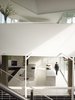Modern home with Kitchen, White Cabinet, Marble Counter, Drop In Sink, and Concrete Floor. View of the kitchen from the staircase Photo 11 of Tehama Grasshopper
