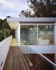 Modern home with Exterior, Metal Roof Material, Metal Siding Material, House, Glass Siding Material, and Flat RoofLine. Outdoor walkway to the master bedroom Photo 6 of 1532 House