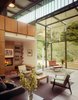 Modern home with Living Room, Standard Layout Fireplace, Bookcase, Sofa, Bench, Chair, Ceiling Lighting, and Concrete Floor. Living room with the fireplace Photo 9 of Jackson Family Retreat