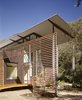 Modern home with Exterior, Metal Siding Material, Wood Siding Material, Glass Siding Material, House Building Type, Butterfly RoofLine, and Metal Roof Material. Entrance of the house Photo 11 of Jackson Family Retreat