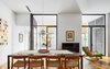 Modern home with Dining Room, Table, Chair, Pendant Lighting, and Medium Hardwood Floor. Mas-aqui renovated a crumbling warehouse with floor-to-ceiling windows that bring in warmth and light. The dining room has a view across the new patio toward the atelier. Photo 3 of Conversion of a ground-floor publisher’s warehouse into a residence and atelier for an artist-architect couple