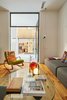 Modern home with Living Room, Sofa, Medium Hardwood Floor, Wall Lighting, Table Lighting, Ceiling Lighting, and Coffee Tables. Living room Photo 4 of Conversion of a ground-floor publisher’s warehouse into a residence and atelier for an artist-architect couple