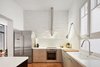 Modern home with Kitchen, Microwave, Metal Cabinet, Dishwasher, Medium Hardwood Floor, Engineered Quartz Counter, Wall Lighting, Ceiling Lighting, Pendant Lighting, Wall Oven, Undermount Sink, Porcelain Tile Backsplashe, Range Hood, and Refrigerator. Kitchen Photo 5 of Conversion of a ground-floor publisher’s warehouse into a residence and atelier for an artist-architect couple