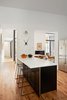 Modern home with Kitchen, Wall Lighting, Laminate Cabinet, Metal Cabinet, Engineered Quartz Counter, Porcelain Tile Backsplashe, Medium Hardwood Floor, and Microwave. Kitchen island Photo 6 of Conversion of a ground-floor publisher’s warehouse into a residence and atelier for an artist-architect couple