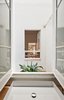 Modern home with Bath Room, Wall Lighting, Wood Counter, Concrete Floor, Freestanding Tub, One Piece Toilet, Ceiling Lighting, Subway Tile Wall, Full Shower, and Vessel Sink. Continuous view from the bathroom Photo 7 of Conversion of a ground-floor publisher’s warehouse into a residence and atelier for an artist-architect couple