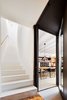 Modern home with Staircase, Concrete Tread, and Wood Railing. Staircase and the extended passageway Photo 9 of Conversion of a ground-floor publisher’s warehouse into a residence and atelier for an artist-architect couple