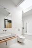 Modern home with Bath Room, Vessel Sink, Wall Lighting, Wood Counter, Ceiling Lighting, Concrete Floor, Subway Tile Wall, and One Piece Toilet. Suite bathroom with skylight Photo 11 of Conversion of a ground-floor publisher’s warehouse into a residence and atelier for an artist-architect couple