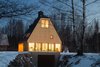 Modern home with Exterior, Metal Roof Material, Wood Siding Material, House Building Type, and Cabin Building Type. Night view from the sea Photo of House by the sea by AB CHVOYA