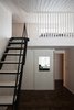 Modern home with Bedroom, Track Lighting, Dark Hardwood Floor, and Storage. Bedroom with mezzanine Photo 10 of House for two artists by AB CHVOYA