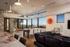 Modern home with Living Room, Ceiling Lighting, Recliner, End Tables, Sectional, Coffee Tables, Media Cabinet, Pendant Lighting, Medium Hardwood Floor, and Ottomans. Open concept great room Photo 5 of New Perspective