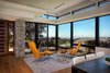 Modern home with Living Room, Ottomans, Recliner, Ceiling Lighting, Medium Hardwood Floor, and End Tables. Lounge space with coastal views Photo 4 of New Perspective