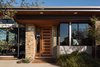 Modern home with Exterior, Hipped RoofLine, House, Stucco Siding Material, and Metal Roof Material. Modern entry door Photo 3 of New Perspective