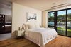 Modern home with Bedroom, Medium Hardwood Floor, Bed, Table Lighting, Night Stands, and Ceiling Lighting. Master bedroom with pool view Photo 10 of New Perspective