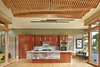 Modern home with Kitchen, Glass Tile Backsplashe, Ceiling Lighting, Wood Cabinet, Wall Oven, Light Hardwood Floor, Cooktops, Refrigerator, Undermount Sink, Pendant Lighting, and Engineered Quartz Counter. Kitchen with undulating wood screen ceiling over dining area Photo 4 of DESCHUTES House