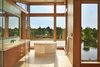 Modern home with Bath Room, Glass Tile Wall, Ceiling Lighting, Porcelain Tile Floor, Full Shower, Freestanding Tub, Undermount Sink, One Piece Toilet, and Engineered Quartz Counter. Master Bath with freestanding tub overlooking Deschutes River Photo 11 of DESCHUTES House