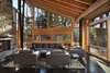 Modern home with Living Room, Standard Layout Fireplace, Ceiling Lighting, Sofa, Coffee Tables, Chair, Concrete Floor, End Tables, and Wood Burning Fireplace. Main living space with Montana ledgestone fireplace Photo 6 of Mazama House
