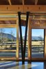 Modern home with Dining Room, Standard Layout Fireplace, Table, Concrete Floor, Chair, and Ceiling Lighting. Distinctive steel "V" columns support the exposed wood beams Photo 8 of Mazama House