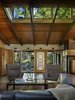Modern home with Living Room, Terrazzo Floor, Two-Sided Fireplace, Sofa, Ceiling Lighting, Coffee Tables, and Chair. Interior view of living area and new entry glass wall Photo 2 of Lake Forest Park Mid Century Renovation