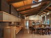 Modern home with Dining Room, Table, Pendant Lighting, Chair, Terrazzo Floor, Two-Sided Fireplace, and Ceiling Lighting. View of dining and kitchen areas with weathered steel wall, cherry cabinets and custom light fixtures. Photo 6 of Lake Forest Park Mid Century Renovation